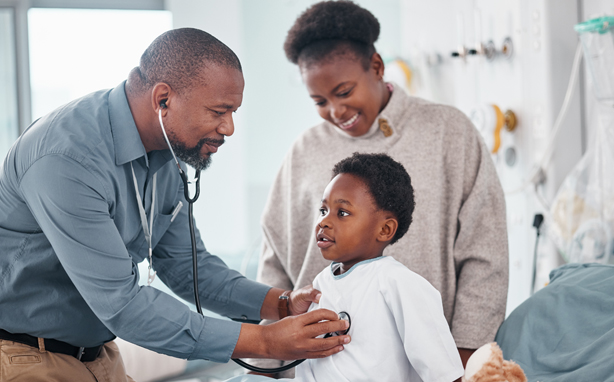 Doctor examines child patient in hospital.