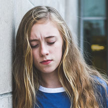 Upset teen outside of hospital.