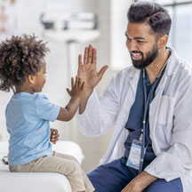 Male doctor and young patient high five.