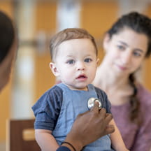 Baby is examined by doctor in the hospital.